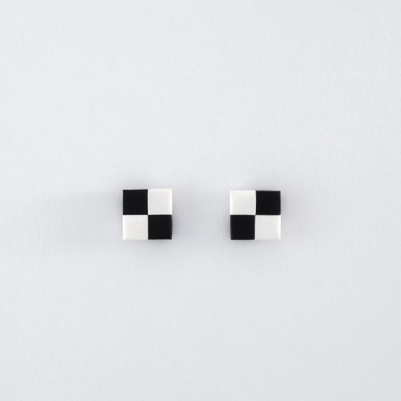 Black & White N°3 handmade stud earrings – checkered black and white squares with 925 sterling silver findings, on light grey background.