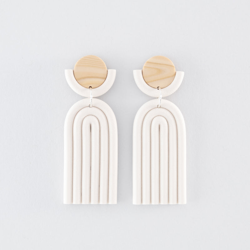 Kyoto N°3 handmade dangle earrings – minimalist, geometric, arch-shapes in white and wooden tones, fitted with 925 sterling silver findings on a light grey background.