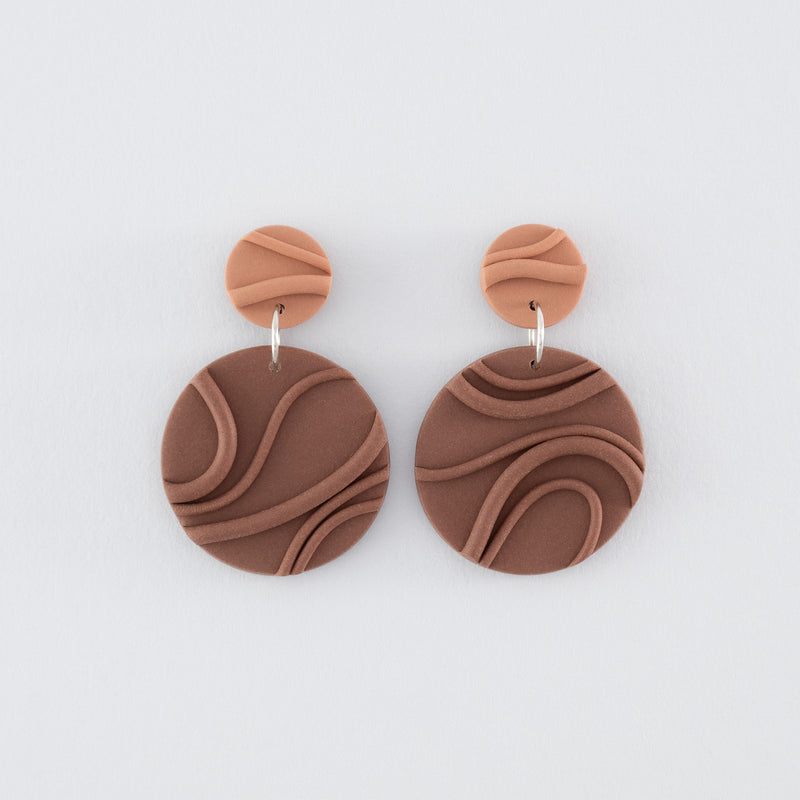 Mocha Mousse N°2 handmade dangle earrings – creamy brown round circular shapes with playful wavy textures and 925 sterling silver findings on light grey background.