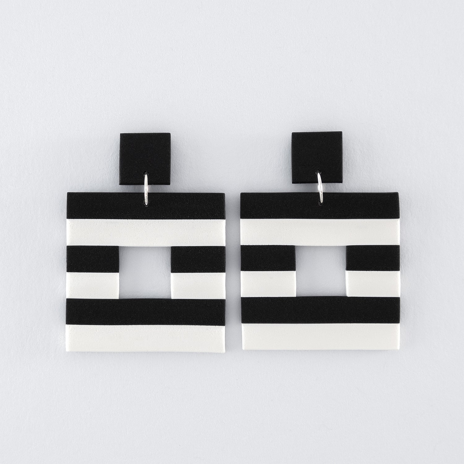 Black & White N°4 handmade dangle earrings – Hollow square, black and white striped earrings with 925 sterling silver findings on light grey background.