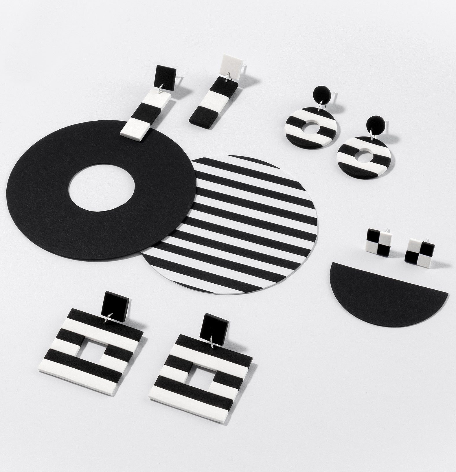 Handmade Black & White earrings – modern, geometric dangles and studs with iconic stripes and checks, featuring 925 sterling silver findings, on white background.