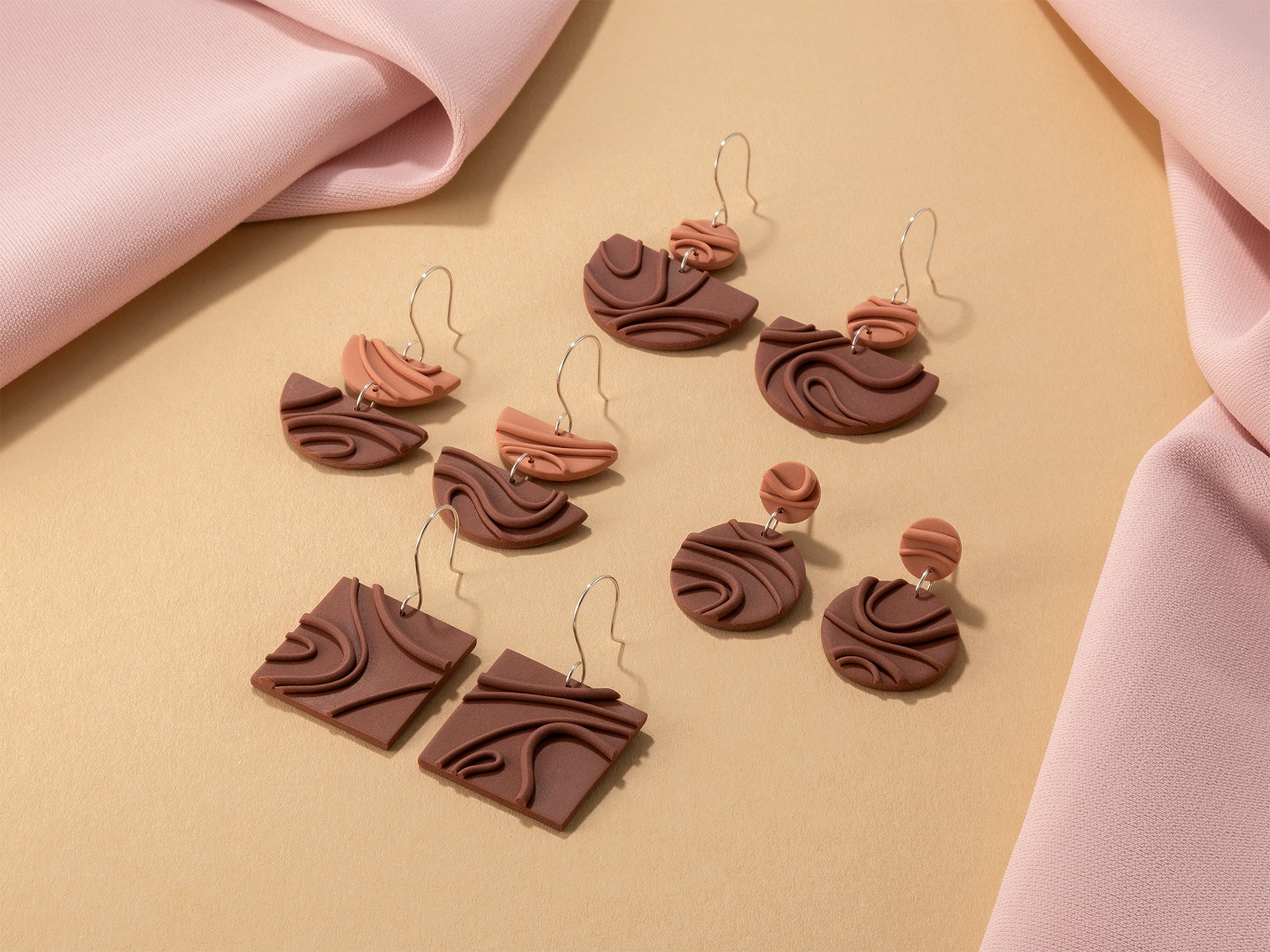 Creamy warm brown Mocha Mousse earrings – modern, geometric dangles with playful textures and 925 sterling silver, on yellow and pink background.