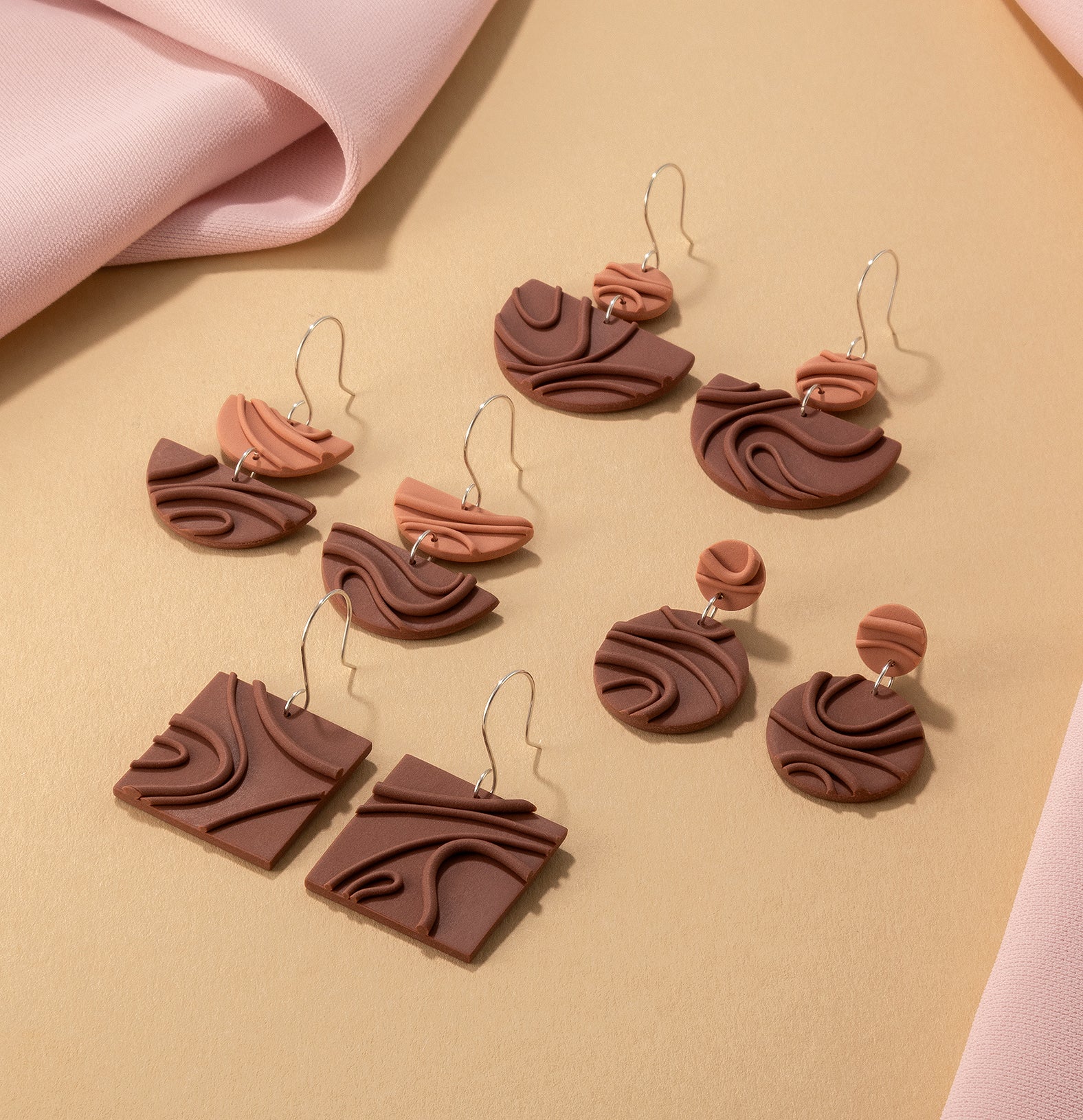 Creamy warm brown Mocha Mousse earrings – modern, geometric dangles with playful textures and 925 sterling silver, on yellow and pink background.