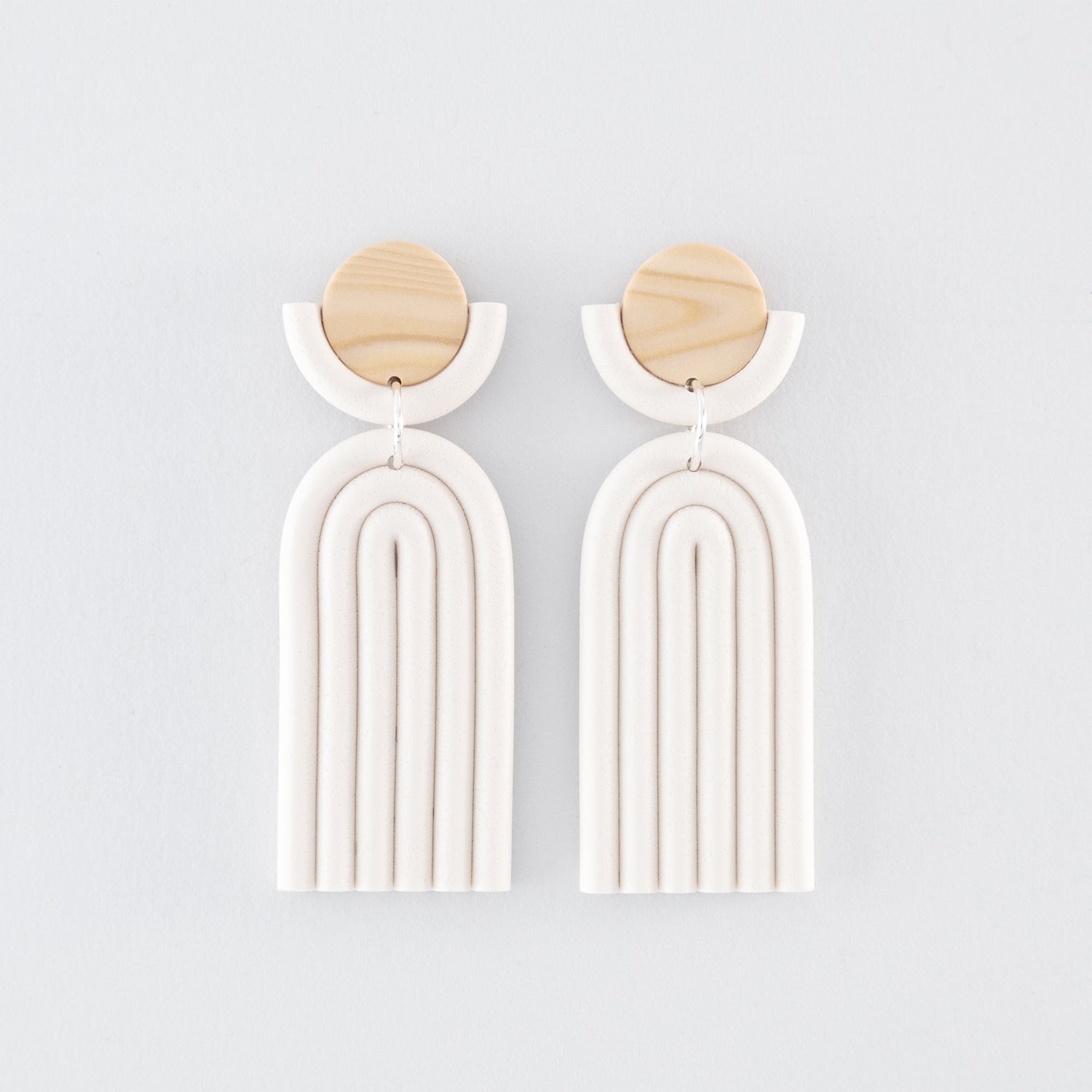 Kyoto N°3 handmade dangle earrings – minimalist, geometric, arch-shapes in white and wooden tones, fitted with 925 sterling silver findings on a light grey background.