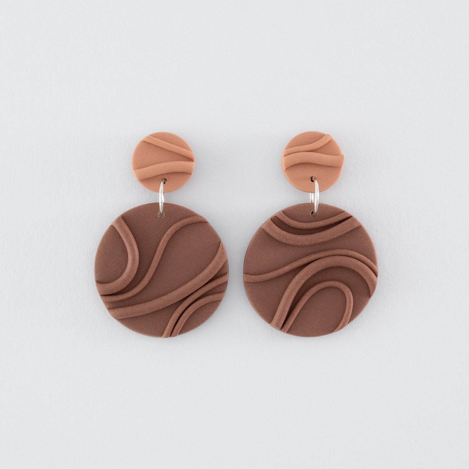 Mocha Mousse N°2 handmade dangle earrings – creamy brown round circular shapes with playful wavy textures and 925 sterling silver findings on light grey background.