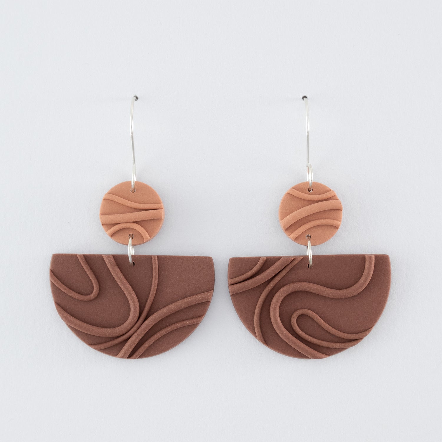 Mocha Mousse N°3 handmade dangle earrings – creamy brown geometric shapes with playful wavy textures and 925 sterling silver findings on light grey background.